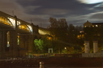 The High Level Bridge stretches across the river under the moonlight